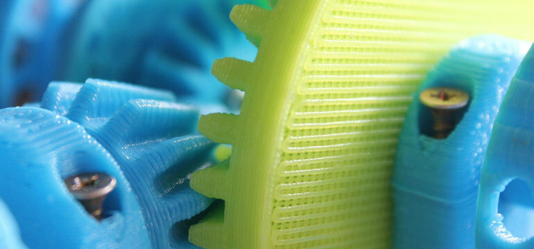 3D Printed Plastic Cogs In Yellow And Blue